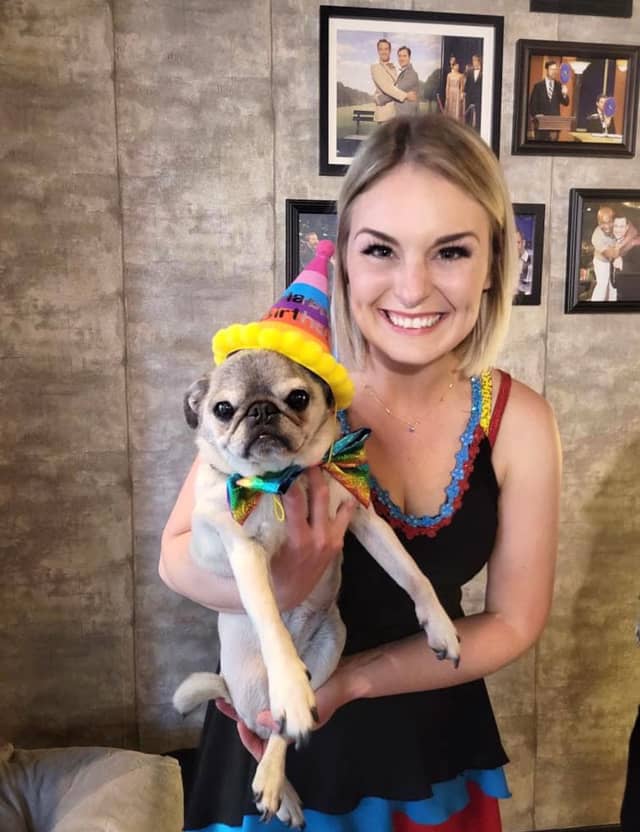 A member of the Farrell Dillon show family holding a pug