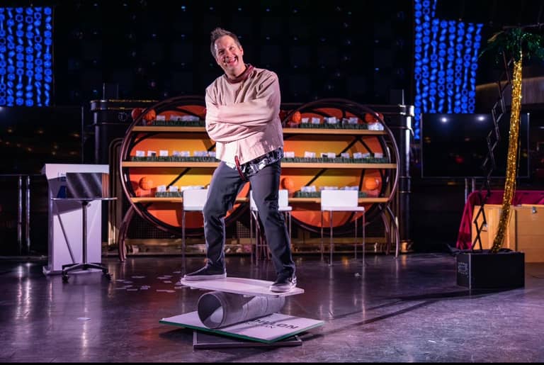 Farrell Dillon balancing on a board and roller during his show