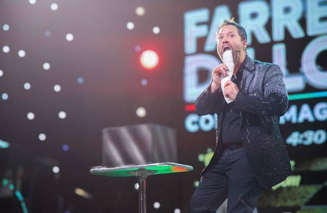 Farrell Dillon speaking to the audience under stage lights