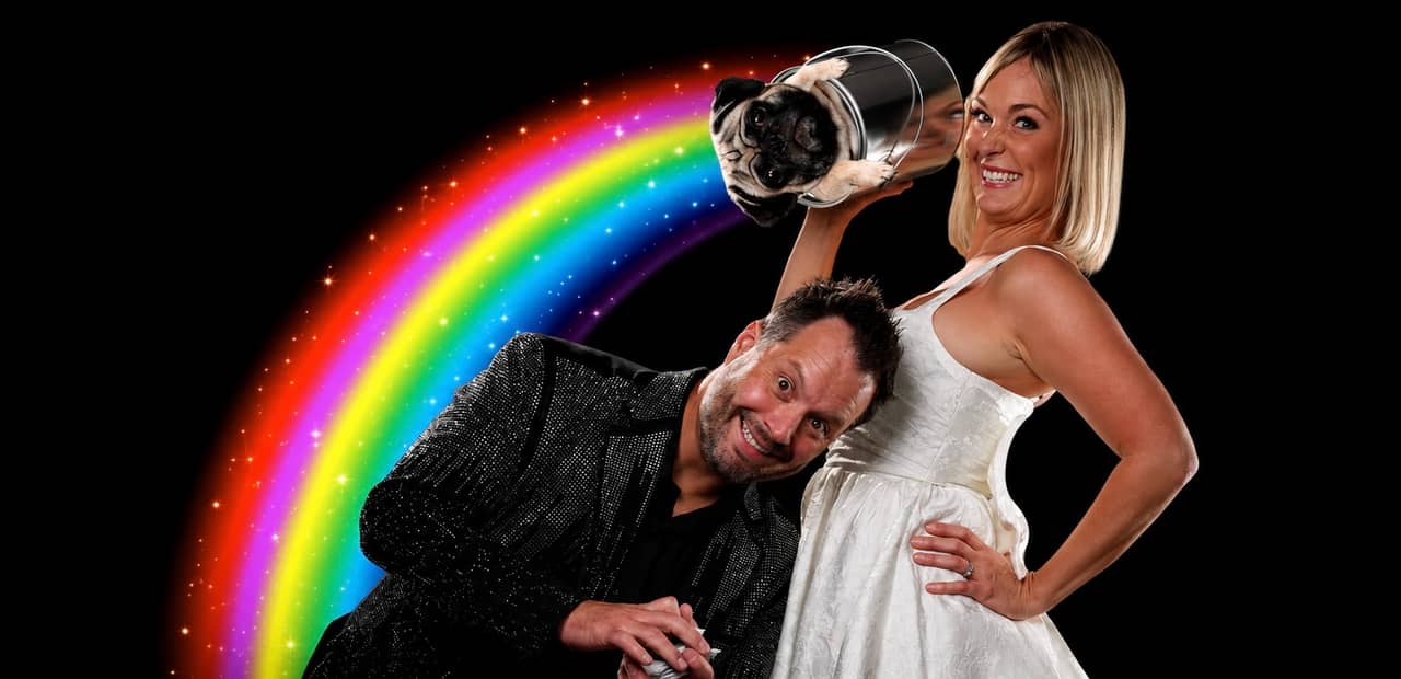 Farrell Dillon and his wife with their pug in a bucket, a rainbow and neon card suits